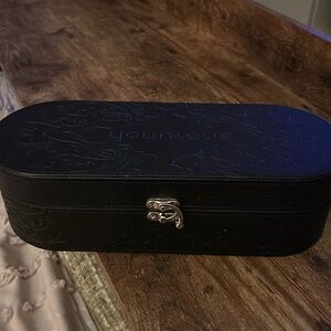 Younique black oval representative make up. Cosmetics case beautiful on vanity
